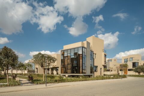 Modern villa design showcasing expansive glass walls, minimalist architecture, and private outdoor green spaces